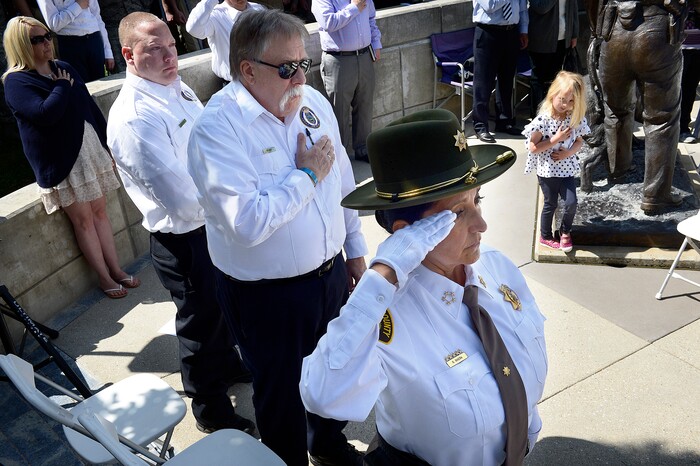 (Scott Sommerdorf | The Salt Lake Tribune)
Salt Lake Tribune columnist Robert Kirby, center, and Salt Lake County Sheriff Rosie Rivera saluted as the colors are struck at the Utah Law Enforcement Memorial to honor the 142 police officers killed in the line of duty during the state's history, Thursday, May 3, 2018.
No Utah law enforcement officer died in the line of duty last year.