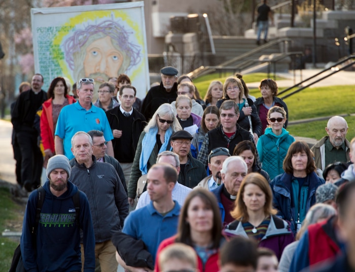 (Rick Egan  |  The Salt Lake Tribune)     Christian faithful follow the cross as they walk with clergy and members of Christian denominations participate in the annual Good Friday procession through downtown Salt Lake City, Friday, March 30, 2018. The procession commemorating Christ's path to crucifixion has been a tradition of the Salt Lake Council of Churches since 1988. 


