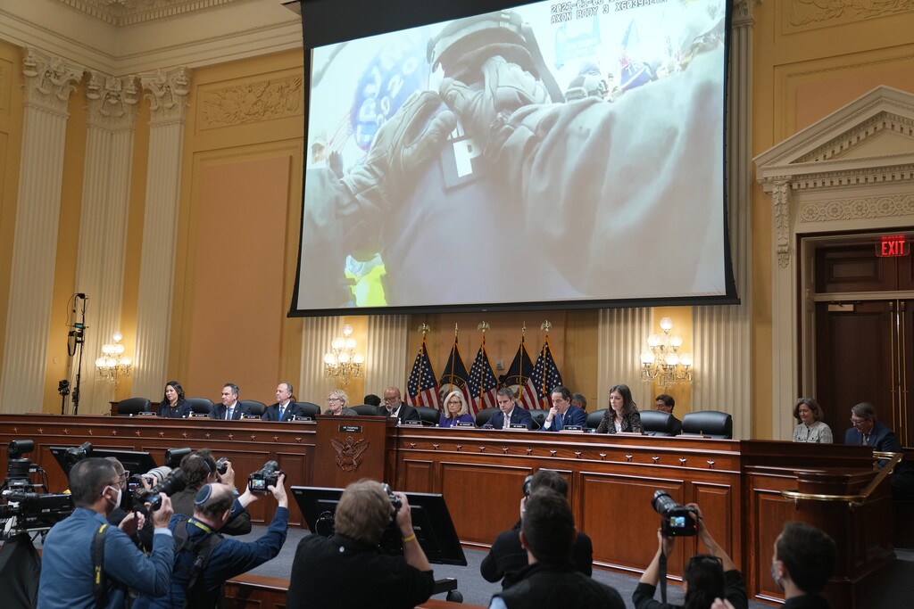 (Haiyun Jiang | The New York Times) Footage from the January 6 attack on the U.S. Capitol is shown during the last public meeting of the House committee investigating the attack, in Washington on Monday, Dec. 19, 2022.