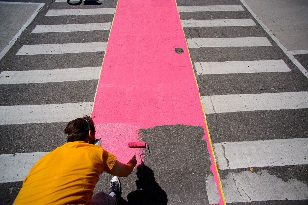 (Trent Nelson  |  The Salt Lake Tribune)  Tyler Bloomquist works on Jann Haworth's Rose art project on Broadway in Salt Lake City on Sunday Aug. 11, 2019.
