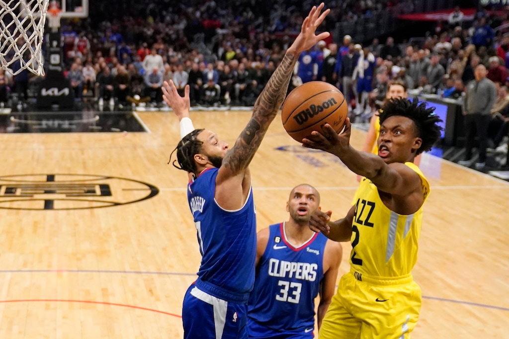 Utah Jazz guard Collin Sexton, right, shoots as Los Angeles Clippers guard Amir Coffey, left, defends and forward Nicolas Batum watches during the second half of an NBA basketball game Monday, Nov. 21, 2022, in Los Angeles. (AP Photo/Mark J. Terrill)