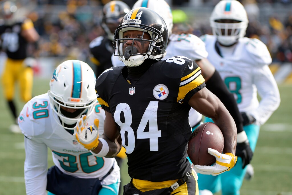 Pittsburgh Steelers wide receiver Antonio Brown (84) gets past Miami Dolphins free safety Bacarri Rambo (30) en route to the end zone for a touchdown during the first half of an AFC Wild Card NFL football game in Pittsburgh, Sunday, Jan. 8, 2017. (AP Photo/Fred Vuich)