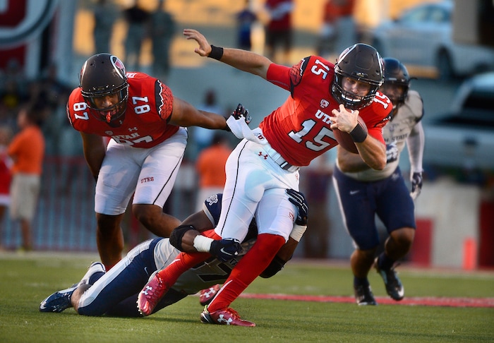 In this Sept. 11, 2015 photo, Utah quarterback Chase Hansen runs with the ball against Utah State at Rice-Eccles Stadium in Salt Lake City. Freshman Chase Hansen is the quarterback of the future for No. 3 Utah, but in the meanwhile, hes switched jerseys and sides of the ball.  (Scott Sommerdorf/The Salt Lake Tribune via AP) DESERET NEWS OUT; LOCAL TELEVISION OUT; MAGS OUT; MANDATORY CREDIT 