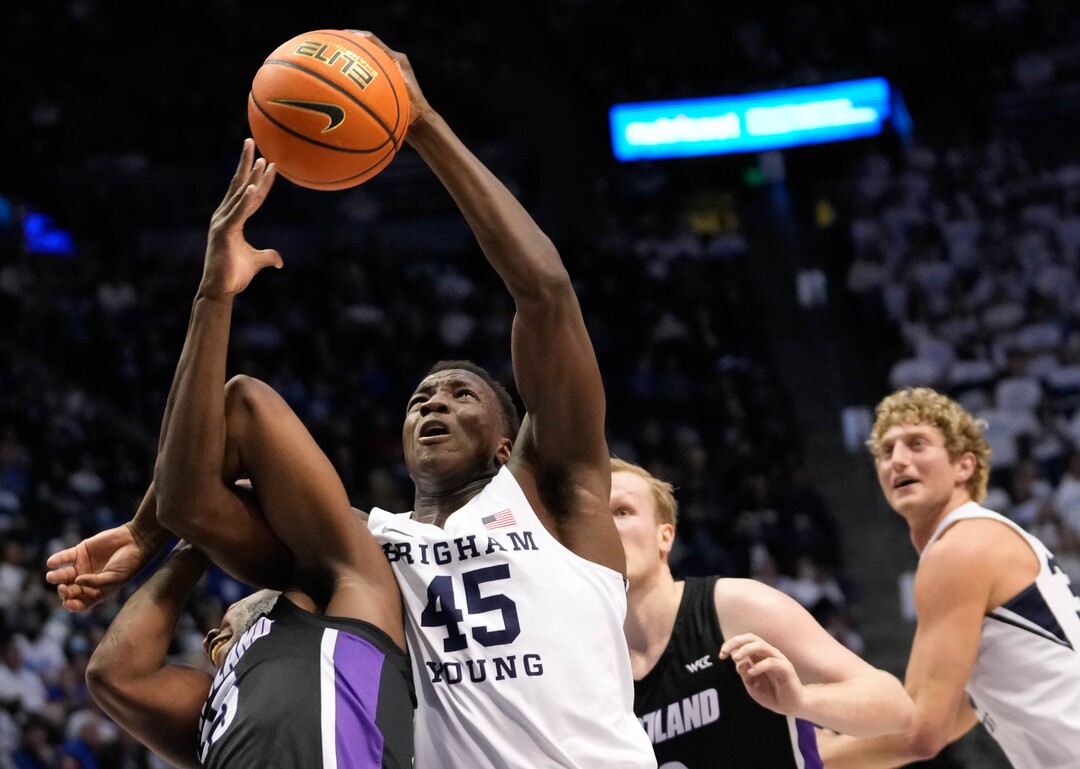 (Francisco Kjolseth | The Salt Lake Tribune) Brigham Young Cougars forward Fousseyni Traore (45) tangles with Portland Pilots guard Chika Nduka (15) in WCC basketball action between the Brigham Young Cougars and the Portland Pilots, at the Marriott Center, on Saturday, January 22, 2022.