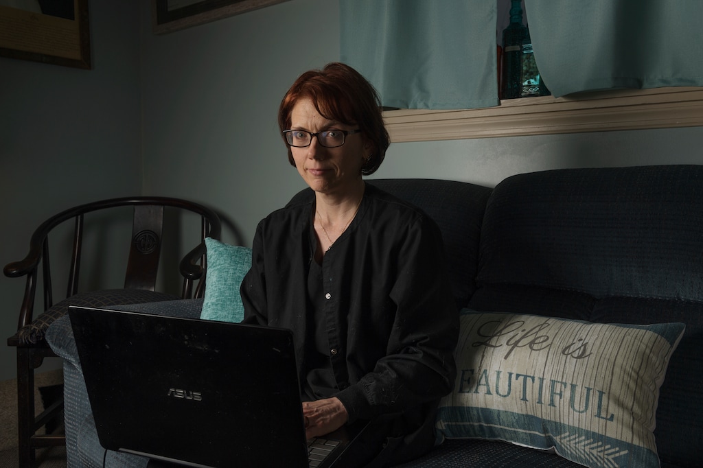 (Craig Hudson | The Associated Press) Kelly Povroznik poses for a portrait inside the living room of her home in Weston, W.Va. Povroznik teaches an online college course that has been hampered by slow connections on her computer and phone. There is widespread agreement that expanding broadband internet in rural America is desperately needed.