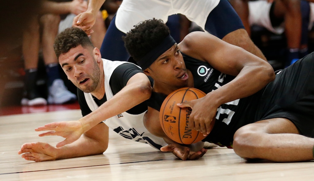 Utah Jazz forward Georges Niang, left, and Atlanta Hawks' Zach LeDay, right, vie for a loose ball during the first half of an NBA summer league basketball game Thursday, July 5, 2018, in Salt Lake City. (AP Photo/Rick Bowmer)