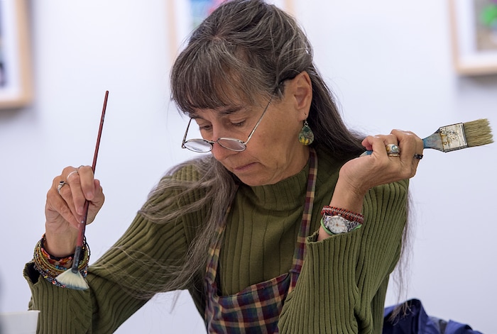 (Leah Hogsten  |  The Salt Lake Tribune)  Nia Sherar paints a winter scene during the Bob Ross Paint-Along class, Saturday, January 6, 2018 at the Salt Lake City Public Library's Sweet Branch in the Avenues. 