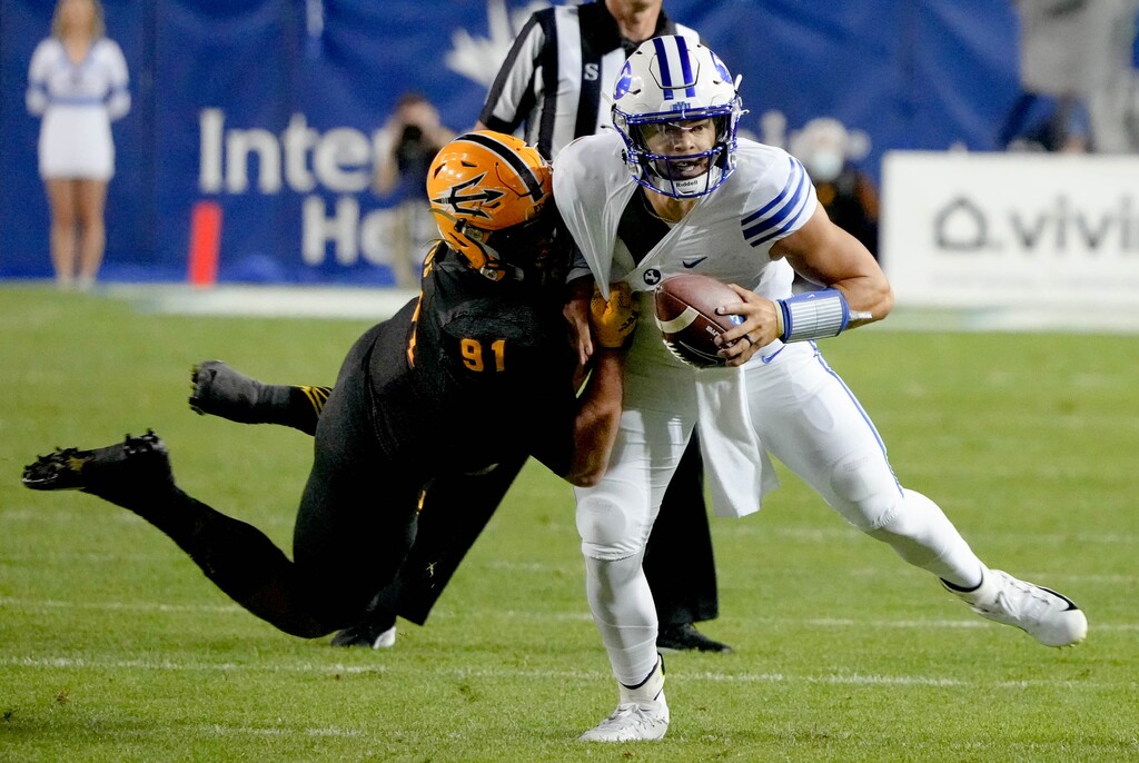 (Francisco Kjolseth | The Salt Lake Tribune) Brigham Young Cougars quarterback Jaren Hall (3) shakes off pressure put on by Arizona State Sun Devils defensive end Michael Matus (91) in football action between the Brigham Young Cougars and the Arizona State Sun Devils at LaVell Edwards Stadium in Provo, on Saturday, Sept. 18, 2021.