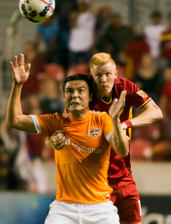 (Rick Egan | The Salt Lake Tribune) Real Salt Lake defender Justen Glad (15) goes for the ball along with Houston Dynamo forward Erick Torres (9), in MLS action, Real Salt Lake Vs. Houston Dynamo, in Sandy, Saturday, August 5, 2017.