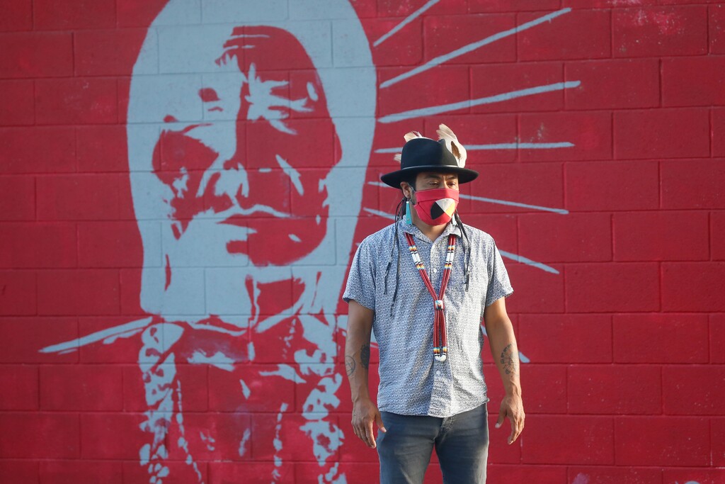 (Rick Bowmer | AP photo)

Native American advocate Carl Moore stands in front of a mural of an Indigenous man meant to represent the Braves mascot at Bountiful High School Tuesday, July 28, 2020, in Bountiful, Utah. While advocates have made strides in getting Native American symbols and names changed in sports, they say there's still work to do mainly at the high school level, where mascots like Braves, Indians, Warriors, Chiefs and Redskins persist.