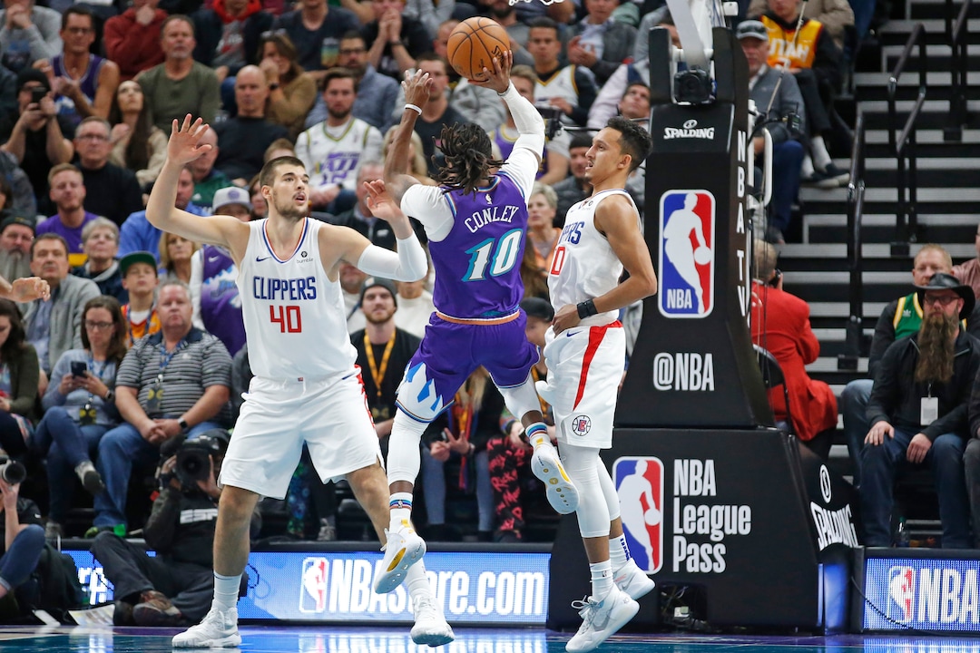 (Rick Bowmer | AP)  Utah Jazz guard Mike Conley (10) shoots as Los Angeles Clippers' Ivica Zubac (40) and Landry Shamet (20) defend during the first half of an NBA basketball game Wednesday, Oct. 30, 2019, in Salt Lake City.