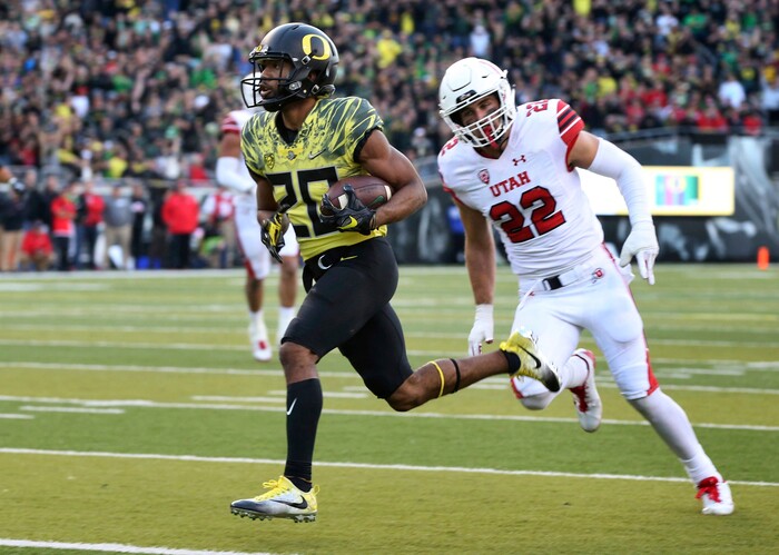 Oregon running back Tony Brooks-James, left, scores a touchdown ahead of Utah's Chase Hansen during the fourth quarter of an NCAA college football game Saturday, Oct. 28, 2017, in Eugene, Ore. (AP Photo/Chris Pietsch)
