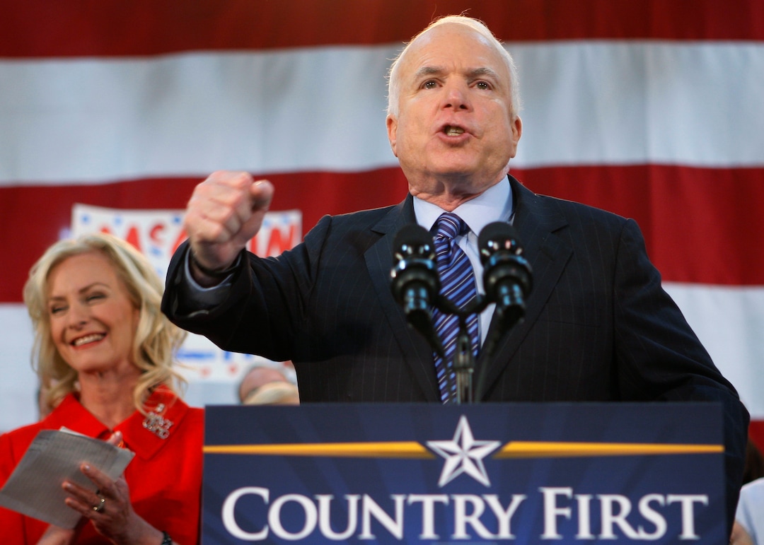 FILE - In this Oct. 21, 2008 file photo, Republican presidential candidate Sen. John McCain, R-Ariz., standing with his wife Cindy, encourages his supporters to stand up and fight for America at the close of his address during a campaign rally in Bensalem, Pa. McCain’s family says the Arizona senator has chosen to discontinue medical treatment for brain cancer.  (AP Photo/Stephan Savoia)