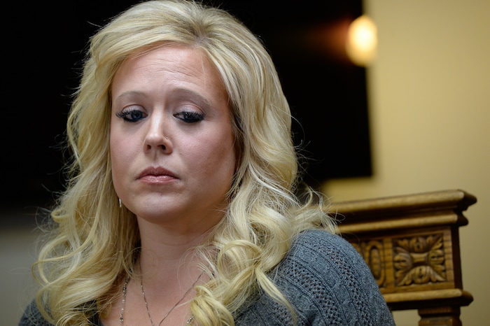 (Francisco Kjolseth | The Salt Lake Tribune) Heather Leyva, listens as her attorney Robert Sykes, discusses the sexual harassment lawsuit he is filing on her behalf against Utah trooper Sgt. Blaine Robbins, during a press conference at his law offices in Salt Lake City Wed. Feb. 7, 2018. According to the lawsuit, the trooper hounded her with unwanted sexually charged messages and used his position and authority to stalk her.