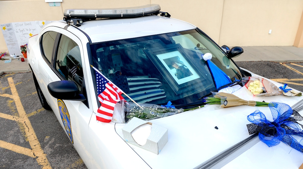 Leah Hogsten | The Salt Lake Tribune South Salt Lake police officer David Romrell's vehicle is decorated with flags, flowers, notes of gratitude and bows in the police department parking lot. South Salt Lake Police Department detective Gary Keller, Lt. Jim Anderson and Unified Police Department investigator Melody Gray held a press conference Nov. 27, 2018 to announce the Dec. 5th funeral procession date for South Salt Lake police officer David Romrell, who died Saturday evening after he was struck by a car during a confrontation between police and two burglary suspects.