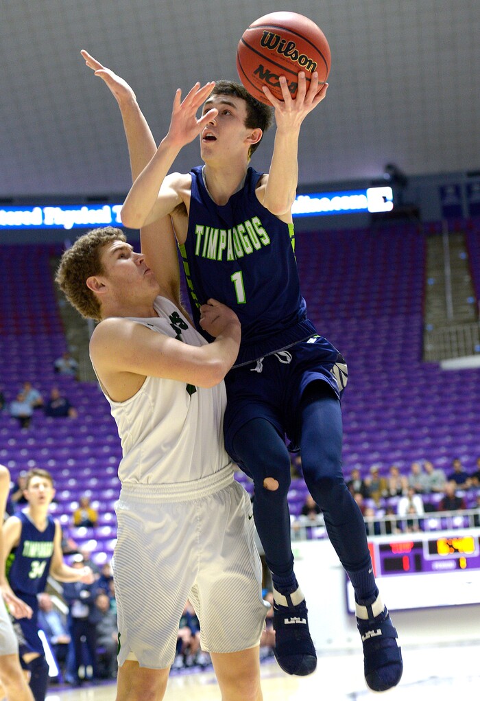 Leah Hogsten  |  The Salt Lake TribuneTimpangos' Dalten Stewart rises to the net over Olympus' Harrison Creer. Olympus High School leads Timpanogos High School 53-27 during their 4A State boysÕ basketball quarterfinal playoff game at Weber State University's Dee Events Center, Thursday, March 2, 2017.