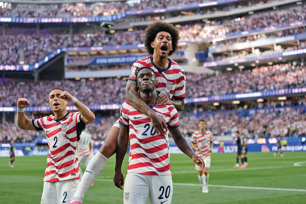 United States' Folarin Balogun (20) celebrates scoring his side's third goal against Paraguay with teamates during the World Cup Group D soccer match in Inglewood, Calif., near Los Angeles, Friday, June 12, 2026. (AP Photo/Andre Penner)