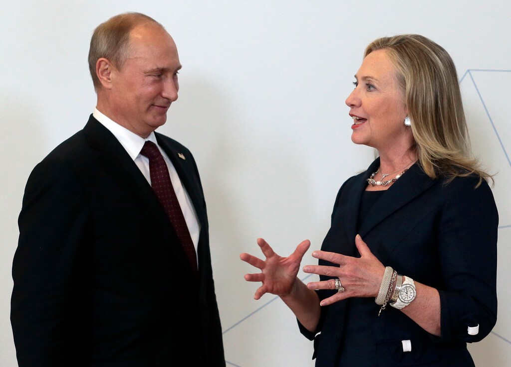 In this file photo taken on Saturday, Sept. 8, 2012, Russian President Vladimir Putin, left, meets U.S. Secretary of State Hillary Rodham Clinton on her arrival at the APEC summit in Vladivostok, Russia.  During her recent acceptance of the Democratic party nomination to run for the U.S. presidency, Clinton said Russia is an enemy and cannot be trusted, a statement which clearly stung the Kremlin and seems to have heralded a new era for the coming presidency if Clinton wins.  (AP Photo/Mikhail Metzel, pool, FILE)