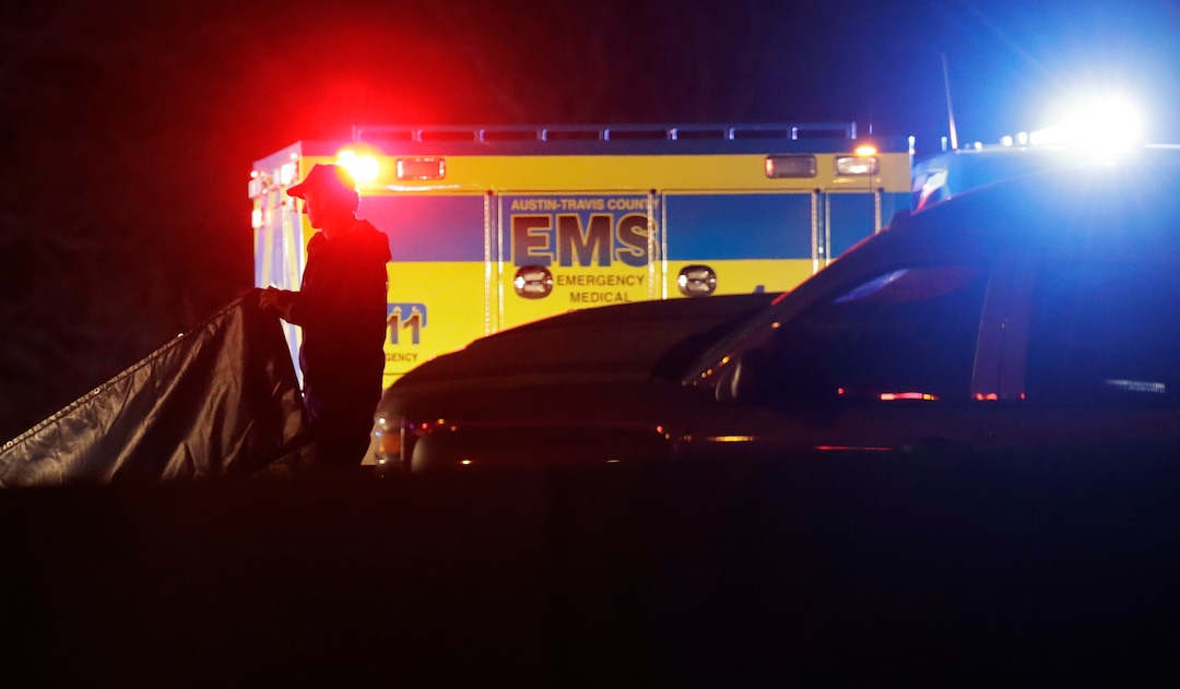 Officials work at the scene where the suspect in a spate of bombing attacks that have terrorized Austin over the past month blew himself up with an explosive device as authorities closed in, the police said early Wednesday, March 21, 2018. (AP Photo/Eric Gay)
