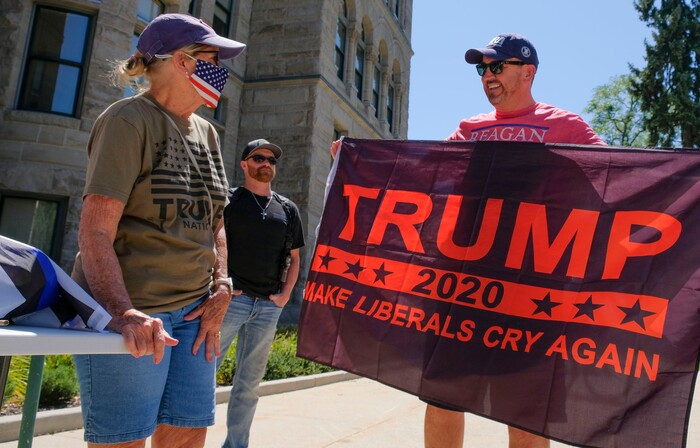 (Leah Hogsten | The Salt Lake Tribune) Hillary Jessup of Park City smiles at former House Speaker Greg Hughes who held Jessup's flag at Back the Blue rally in support of law enforcement, Saturday, August 15, 2020 at Washington Square.