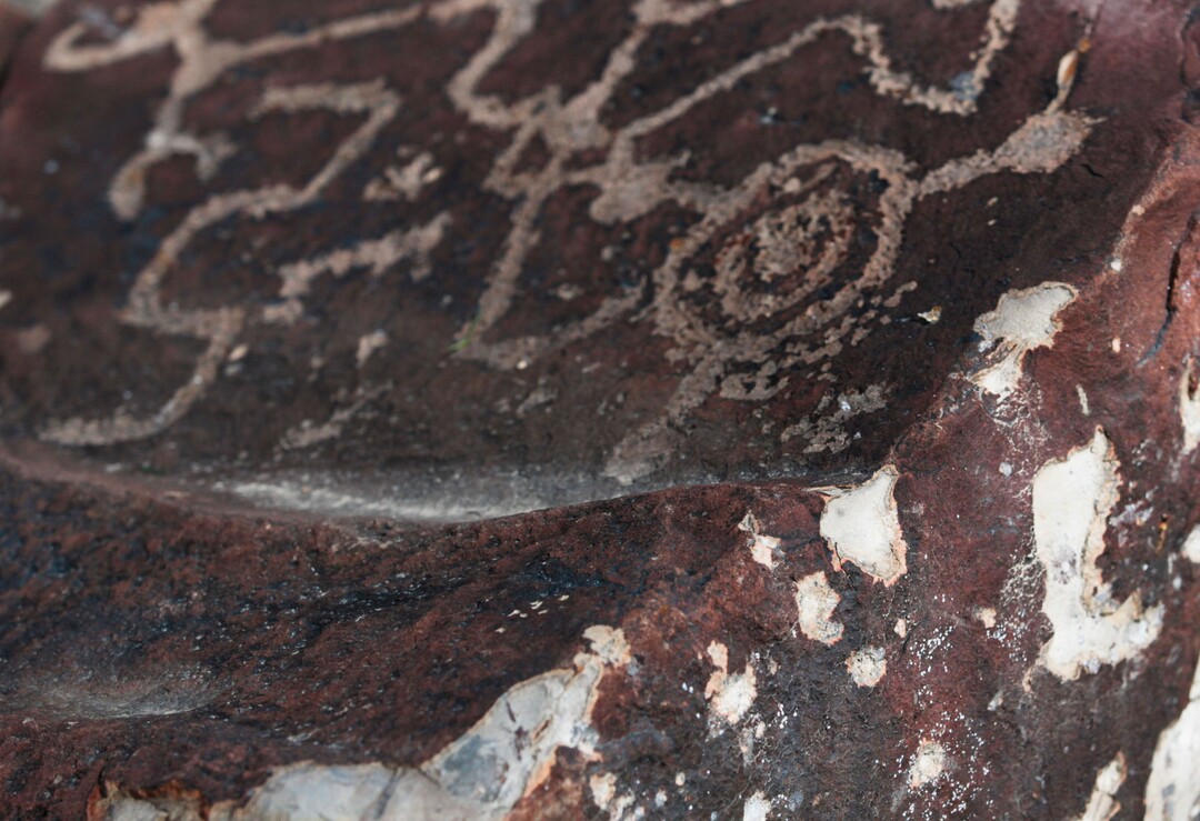 Bullet impacts cover the side of a rock, which contains petroglyphs on the top of the rock, on Thursday, Feb. 8, 2018, in the Lake Mountains area of Utah. (Evan Cobb/The Daily Herald via AP)