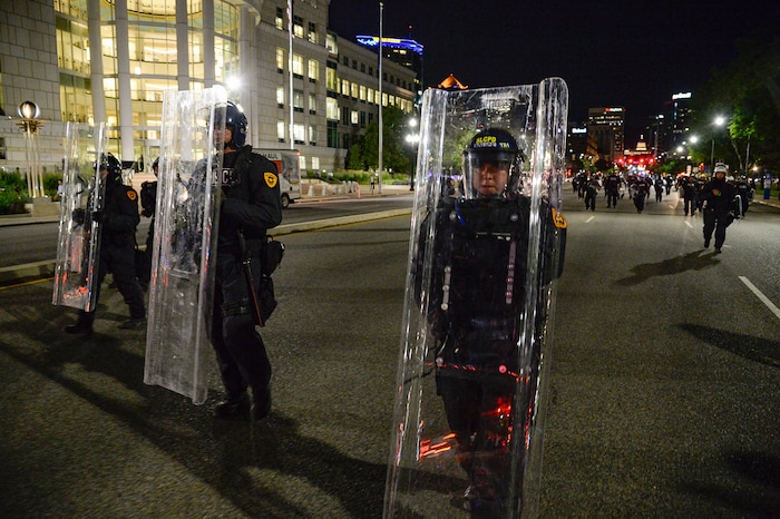 (Francisco Kjolseth  |  The Salt Lake Tribune) Police with shields fill the north bound lane of State street and push people south as they enforce a mandatory curfew in Salt Lake City on Monday, June 1, 2020, following violence and unrest over the weekend due to the death of George Floyd by police.
