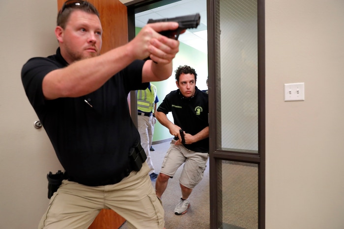 (Tony Gutierrez | AP Photo) In this July 21, 2019 photo, Trainees Chris Graves, left, and Bryan Hetherington, right, participate in a security training session at Fellowship of the Parks campus in Haslet, Texas. An industry has sprung up following mass shootings at houses of worship around the country to train civilians to protect their churches with the techniques and equipment of law enforcement.