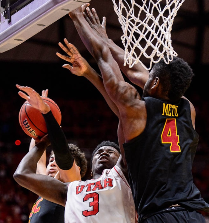 (Trent Nelson | The Salt Lake Tribune)  USC Trojans guard Jordan Usher (1) fouls Utah Utes forward Donnie Tillman (3) as the University of Utah hosts USC, NCAA basketball at the Huntsman Center in Salt Lake City, Saturday Feb. 24, 2018. USC Trojans forward Chimezie Metu (4) at right.