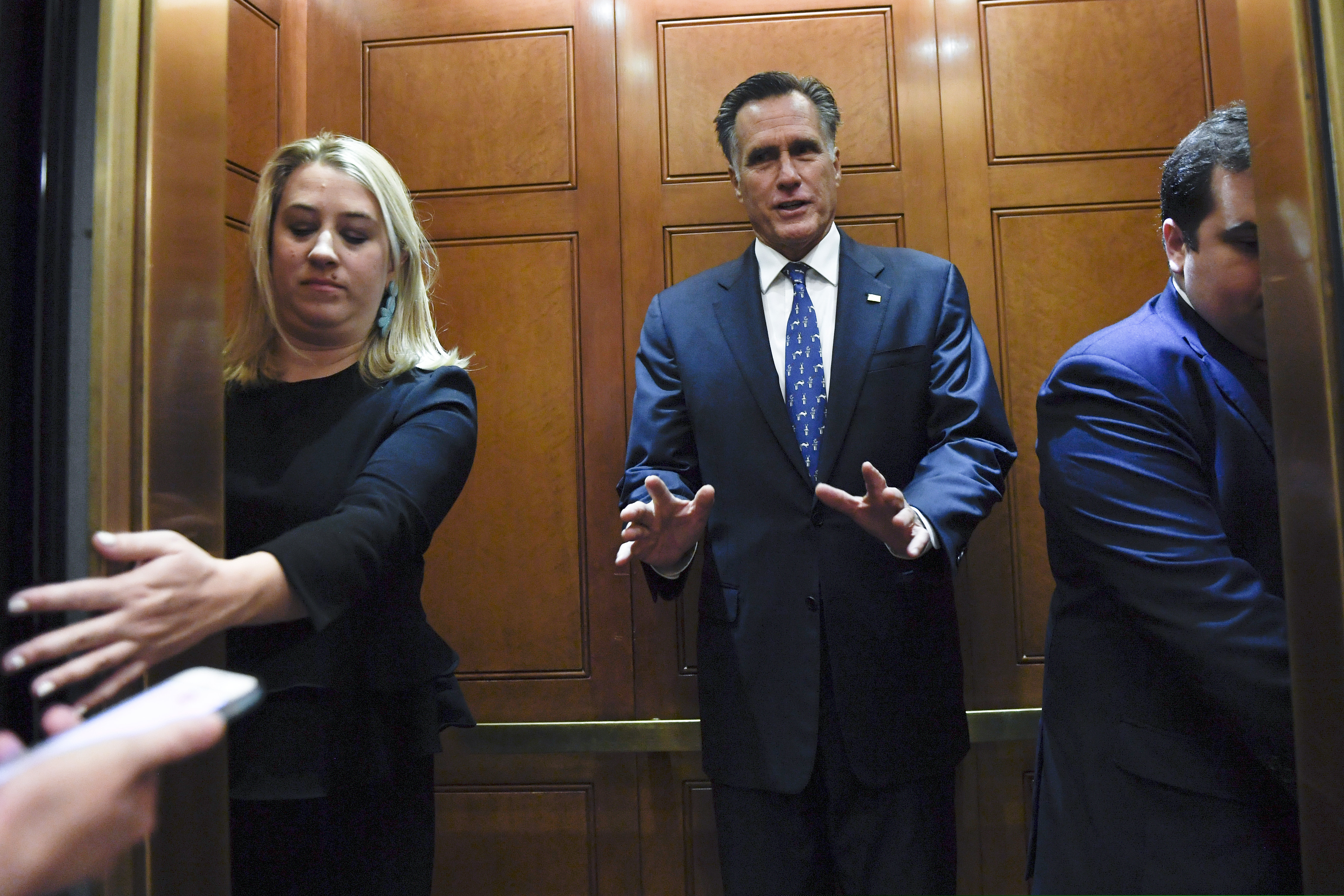 (Susan Walsh | AP file photo) In this Nov. 5, 2019, file photo, Sen. Mitt Romney, R-Utah, gets in an elevator as he is followed by reporters on Capitol Hill in Washington.