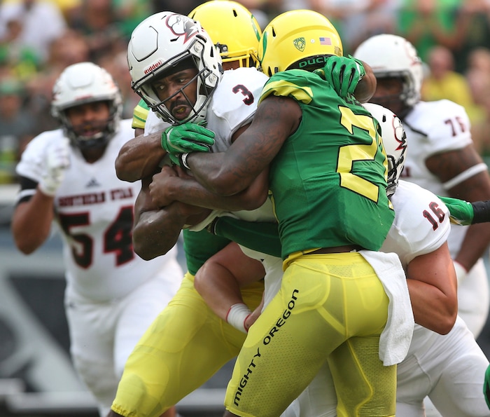 Southern Utah quarterback Patrick Tyler, left, drags Oregon safety Mattrell McGraw into the end zone for a touchdown during the fist quarter of an NCAA college football game Saturday, Sept. 2, 2017, in Eugene, Ore. (AP Photo/Chris Pietsch)