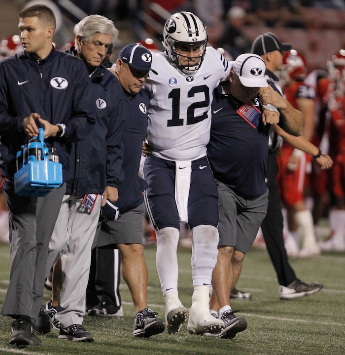 BYU's quarterback Tanner Mangum is helped off the field with an injury against Fresno State during the second half of an NCAA college football game in Fresno, Calif., Saturday, Nov. 4, 2017. Fresno State won the game 20-13. (AP Photo/Gary Kazanjian)