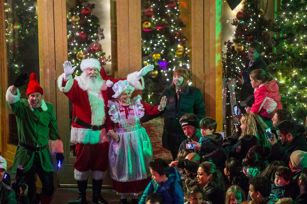 Chris Detrick | The Salt Lake Tribune
Santa Claus, Mrs. Claus and an elf wave to families as they arrives at City Creek Center Thursday November 20, 2014. SantaÕs arrival marks the beginning of the downtown holiday season, along with City Creek CenterÕs 750,000 lights and dcor, choreographed holiday fountain and fire shows, and animated storybook lanterns along the creek. To add to its holiday traditions, City Creek Center will debut a new storybook lantern with a Zoetrope animation of Rudolph the Red-nosed Reindeer.