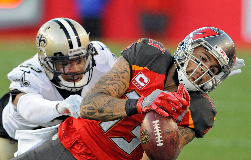 Tampa Bay Buccaneers wide receiver Mike Evans (13) can't hang onto a pass from quarterback Jameis Winston after getting past New Orleans Saints cornerback Marshon Lattimore (23) during the first half of an NFL football game Sunday, Dec. 31, 2017, in Tampa, Fla. (AP Photo/Steve Nesius)