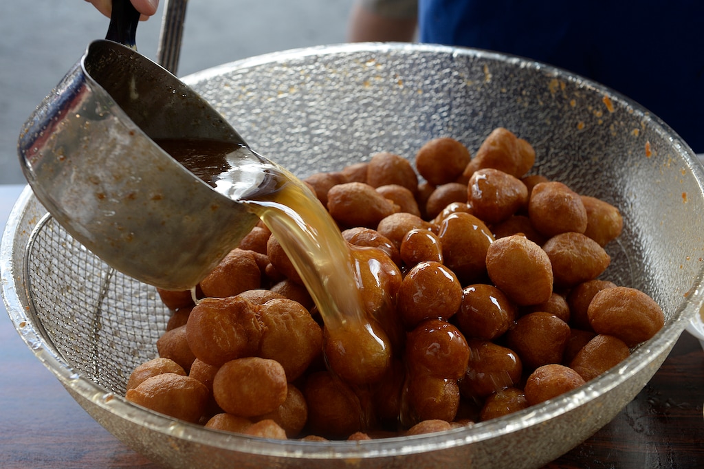 (Scott Sommerdorf | Tribune file photo) Warm honey is poured over fresh loukoumathes during Salt Lake City's annual Greek Festival. This year's festival was canceled due to COVID-19, so organizers are selling the sweet treat and other desserts to go on Saturday, Oct. 17, at Holy Trinity Greek Orthodox Cathedral, 279 S. 300 West, Salt Lake City.