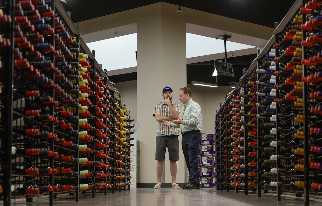 (Francisco Kjolseth | Tribune file photo)
Brett Smith, left, speaks with Cade Meier, deputy director of the DABC, at the West Valley City liquor store on Monday, June 12, 2017.