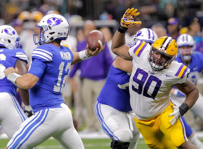 LSU defensive end Rashard Lawrence (90) BYU quarterback Tanner Mangum (12) in the second half of an NCAA college football game in New Orleans, Saturday, Sept. 2, 2017. (AP Photo/Scott Threlkeld)
