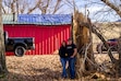 (Trent Nelson  |  The Salt Lake Tribune) Mindie and Jamie Buttars stand next to the remains of a massive tree that fell on top of their coffee roastery in Paradise, Thursday, Dec. 11, 2025.