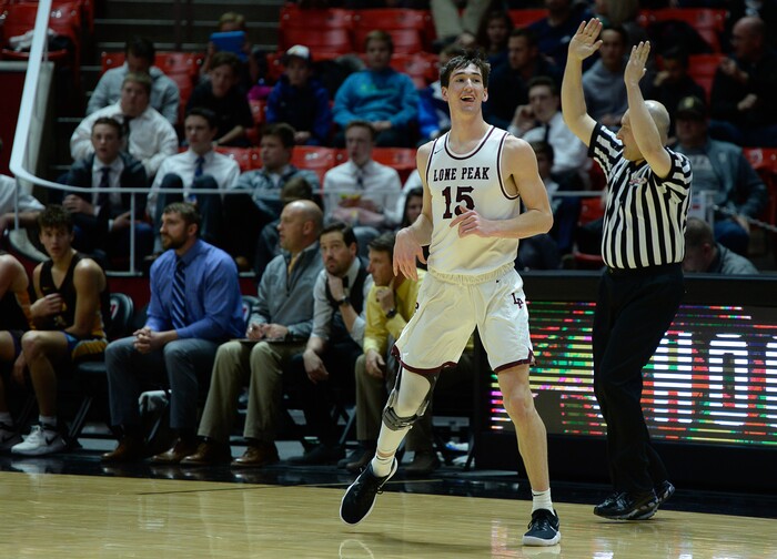(Francisco Kjolseth  |  The Salt Lake Tribune)  Davis vs Lone Peak, 6A State high school basketball tournament at the Huntsman Center in Salt Lake City, Thursday March 1, 2018. Jaxon Pollard (15) celebrates a three-pointer over Davis. 