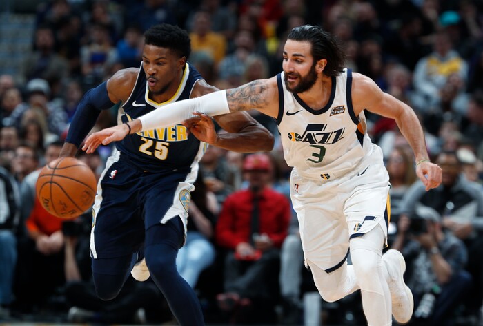 Denver Nuggets guard Malik Beasley, left, pursues the ball with Utah Jazz guard Ricky Rubio, of Spain, in the first half of an NBA basketball game Friday, Jan. 5, 2018, in Denver. (AP Photo/David Zalubowski)