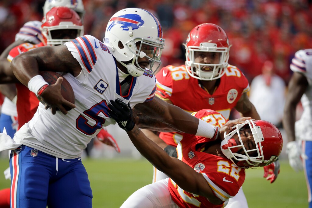 Buffalo Bills quarterback Tyrod Taylor (5) stiff-arms Kansas City Chiefs defensive back Marcus Peters (22) during the first half of an NFL football game in Kansas City, Mo., Sunday, Nov. 26, 2017. (AP Photo/Charlie Riedel)