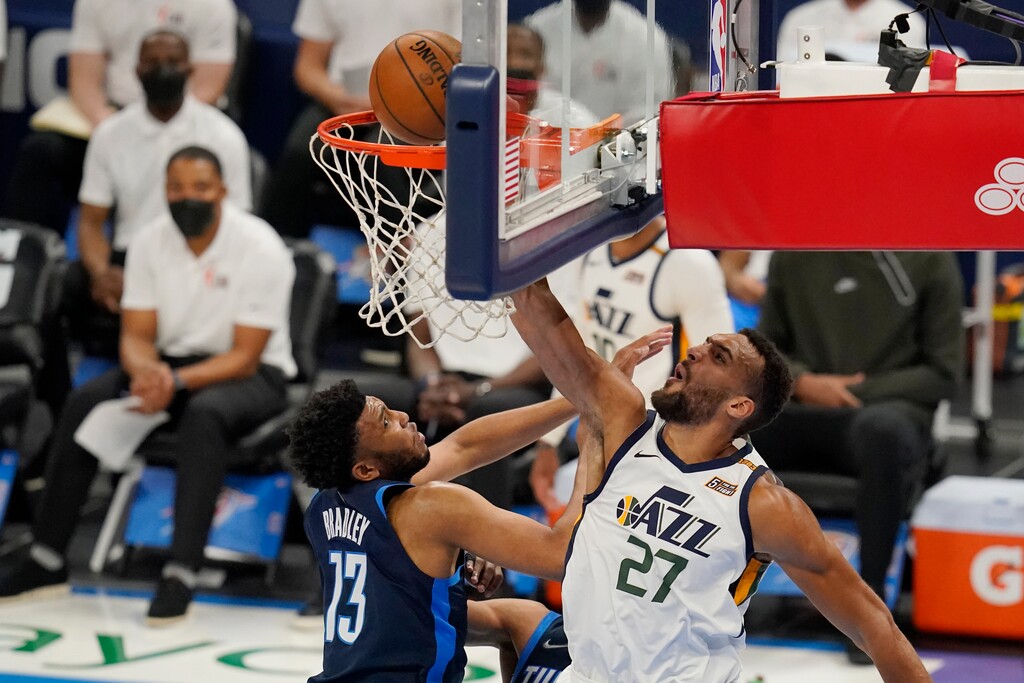 Utah Jazz center Rudy Gobert (27) dunks in front of Oklahoma City Thunder center Tony Bradley (13) in the first half of an NBA basketball game Friday, May 14, 2021, in Oklahoma City. (AP Photo/Sue Ogrocki)