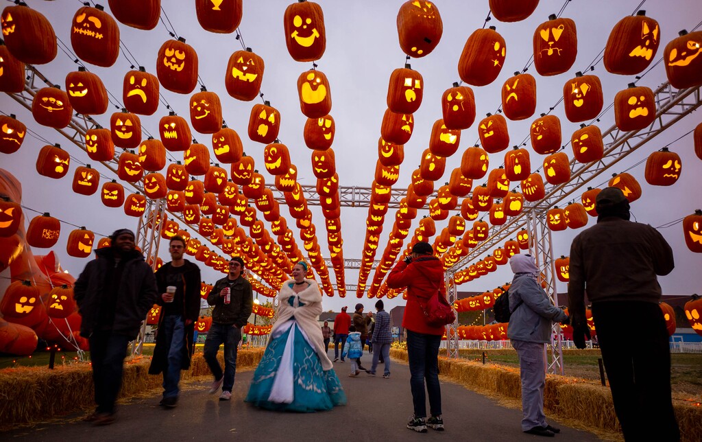 (Trent Nelson  |  The Salt Lake Tribune) Visitors walk through the Pumpkin Passage at Pumpkin Nights at the Utah State Fairpark in Salt Lake City on Monday Oct. 28, 2019.