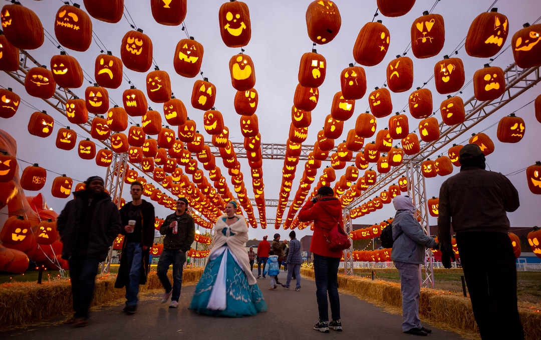 (Trent Nelson  |  The Salt Lake Tribune)
Visitors walk through the Pumpkin Passage at Pumpkin Nights at the Utah State Fairpark in Salt Lake City on Monday, Oct. 28, 2019.