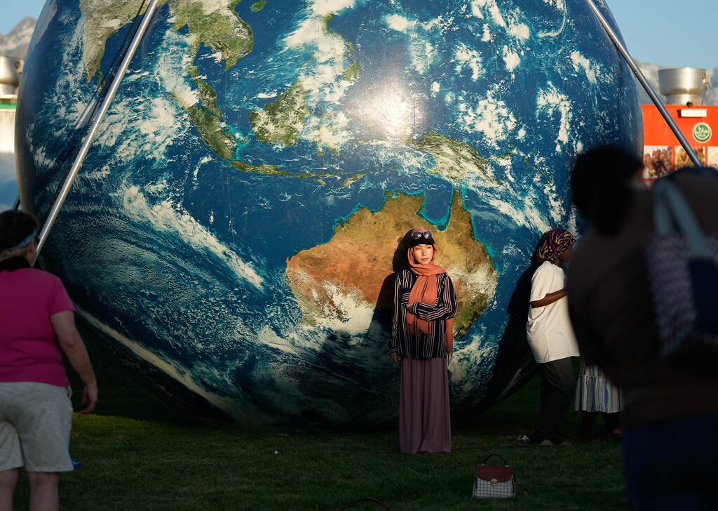 (Francisco Kjolseth | The Salt Lake Tribune) People pose for photographs as they celebrate the 20th anniversary of World Refugee Day at Big Cottonwood Park on Friday, June 21, 2024. Kids play with soap bubbles as they join the celebration for the 20th anniversary of World Refugee Day at Big Cottonwood Park on Friday, June 21, 2024.