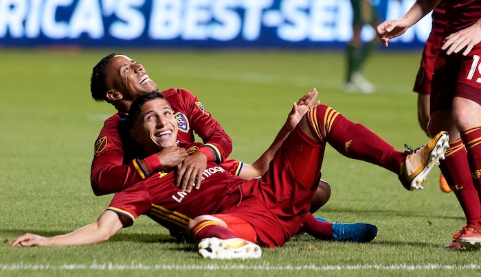 (Michael Mangum  |  Special to the Tribune)  Real Salt Lake forward Joao Plata (10) tackles Real Salt Lake forward Jefferson Savarino (7) to the ground in celebration of Savarino's second half goal during their MLS match against the Portland Timbers at Rio Tinto Stadium in Sandy, UT on Saturday, September 16, 2017.