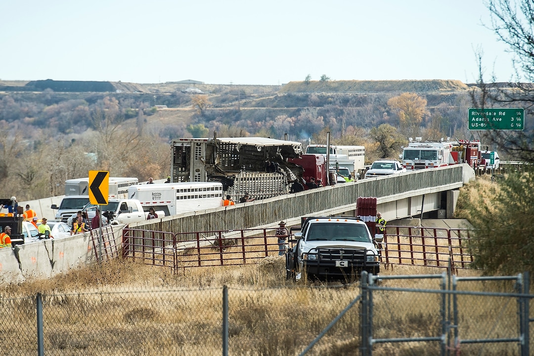 (Chris Detrick  |  The Salt Lake Tribune)  Emergency crews respond to a crashed semi truck hauling cattle on an Interstate 84 overpass in Riverdale Wednesday, November 22, 2017.  While taking the I-15 southbound ramp onto eastbound I-84 at 11:30 a.m., the weight in the semi truck shifted, and the truck tipped over, according to Utah Highway Patrol officials. The truck driver had been speeding, UHP said.