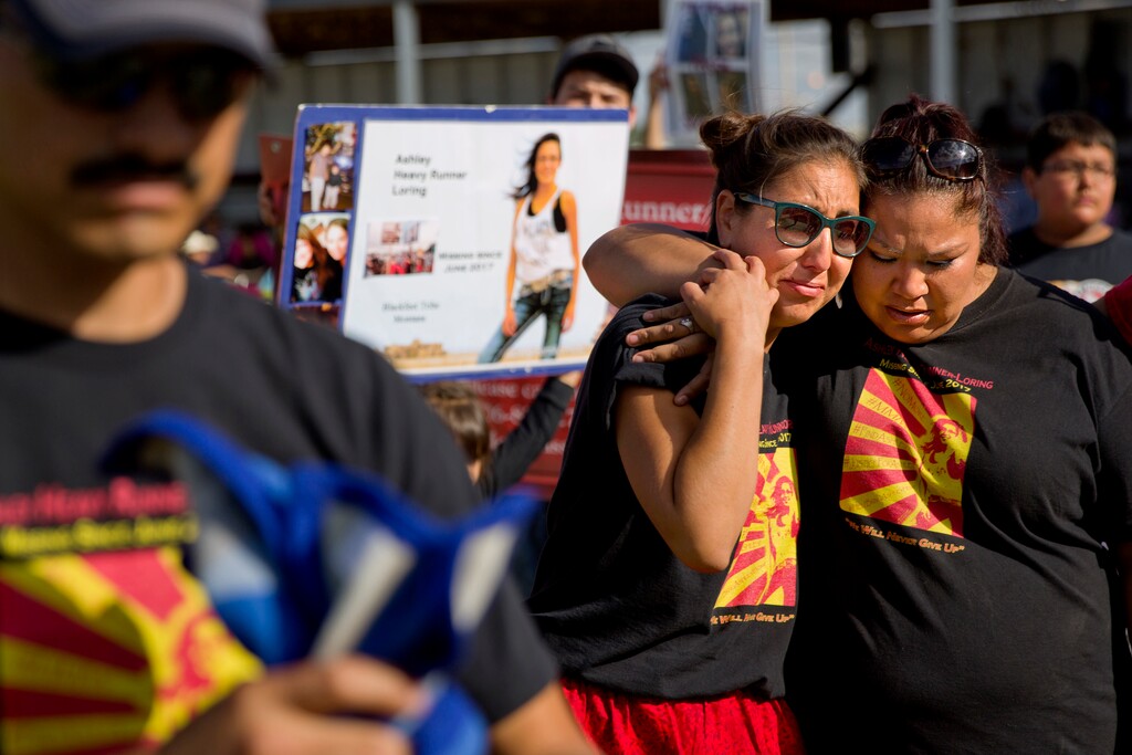 FILE - I this July 14, 2018 file photo, Jenna Loring, left, the aunt of Ashley HeavyRunner Loring, cries with her cousin, Lissa Loring, during a traditional blanket dance before the crowd at the North American Indian Days celebration on the Blackfeet Indian Reservation in Browning, Mont. The 'dance' was held to raise awareness and funds for Ashley's search. A top U.S. Justice Department official says it’s doubling the amount of federal funding for tribal public safety and crime victims as it seeks to tackle the high-rates of violence against Native American women. An announcement on Wednesday, Sept. 19, 2018, comes amid increased focus on the deaths and disappearances of Native American women and girls in the United States. (AP Photo/David Goldman, File)