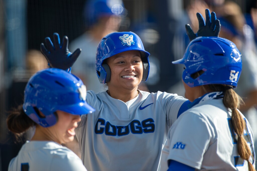 (Tyler Tate | AP) BYU infielder Martha Epenesa (center) celebrates with teammates Marissa Chavez (left) and Huntyr Ava (right) after a home run during an NCAA softball game on Friday, April 23, 2021 in Provo.