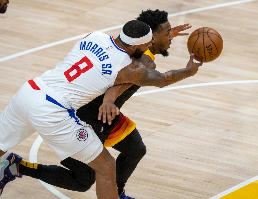 (Rick Egan | The Salt Lake Tribune) Utah Jazz guard Donovan Mitchell (45) plows pas LA Clippers forward Marcus Morris Sr. (8) for two points, in second round playoff action in game 2 between the Utah Jazz and the LA Clippers, at Vivint Arena, on Thursday, June 10, 2021.