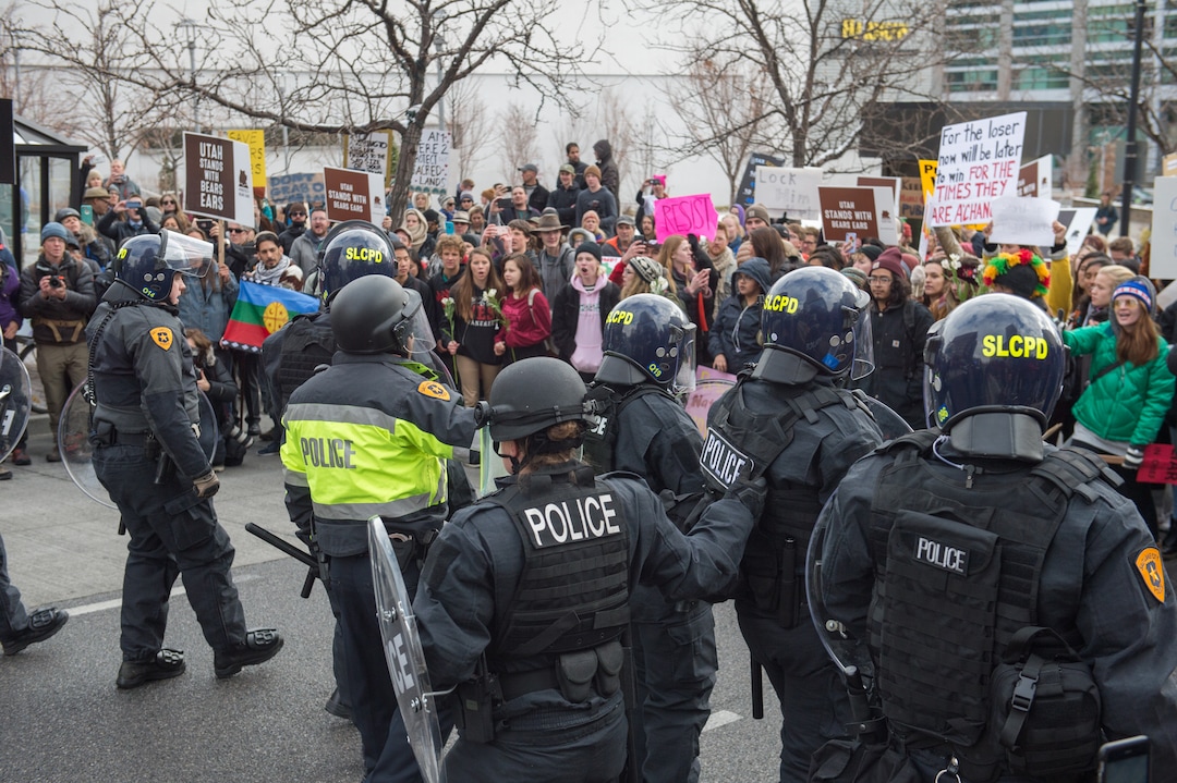(Rachel Molenda  |  The Salt Lake Tribune)  Police retrieve their fellow officers on State Street and 100 S in Salt Lake City, Utah, on Monday, December 4, 2017.